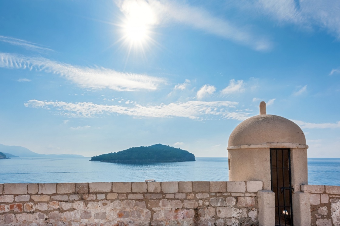 'Gun turret on old city walls of Dubrovnik city (Croatia) with island Lokrum in background.' - Dubrownik